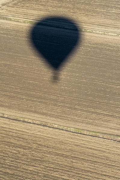 Mantova, Lombardy, Italy, Europe. Crossing the alps in a hot air balloon. landing in a field