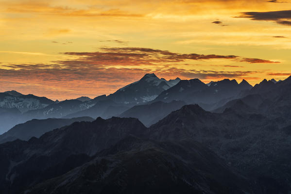 Sand in Taufers / Campo Tures, Bolzano province, South Tyrol, Italy. Sunrise at the summit of Speikboden with view to the Dreiherrnspitze