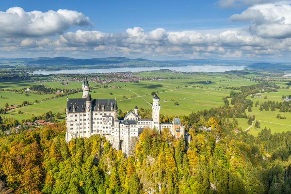 Schwangau, district Ostallgäu, Swabia, Bavaria, Germany, Europe. Autumn at the Neuschwanstein castle, in the background the Forggen lake