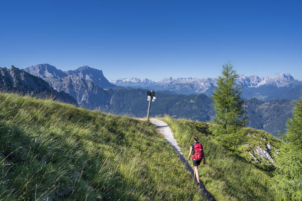 Valdaora / Olang, Bolzano province, South Tyrol, Italy, Europe. A girl hikes the trail to the summit of Piz da Peres (MR)