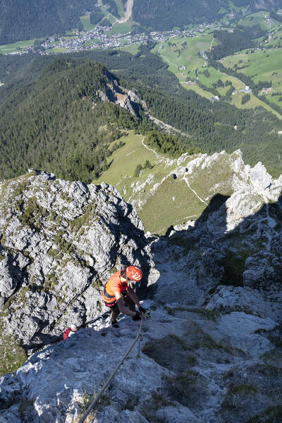 Valdaora / Olang, Bolzano province, South Tyrol, Italy, Europe. A girl on the via ferrata to the summit of Piz da Peres