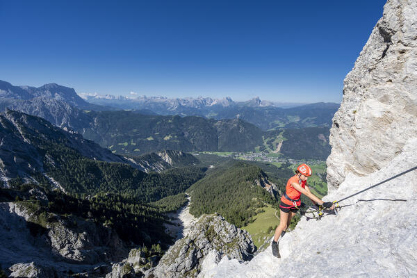 Valdaora / Olang, Bolzano province, South Tyrol, Italy, Europe. A girl on the via ferrata to the summit of Piz da Peres