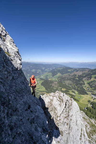 Valdaora / Olang, Bolzano province, South Tyrol, Italy, Europe. A girl on the via ferrata to the summit of Piz da Peres