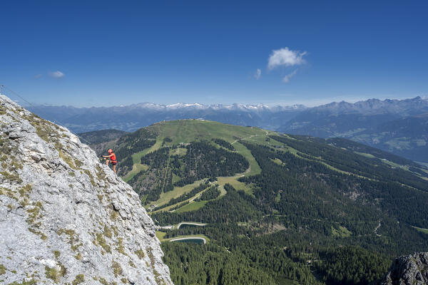 Valdaora / Olang, Bolzano province, South Tyrol, Italy, Europe. A girl on the via ferrata to the summit of Piz da Peres
