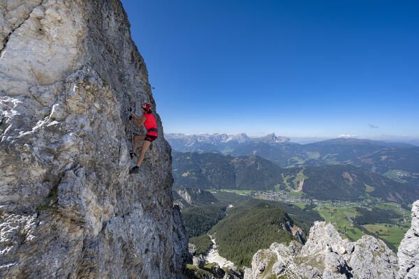 Valdaora / Olang, Bolzano province, South Tyrol, Italy, Europe. A girl on the via ferrata to the summit of Piz da Peres