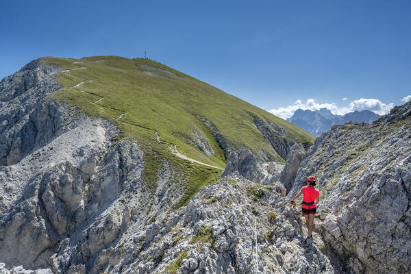 Valdaora / Olang, Bolzano province, South Tyrol, Italy, Europe. A girl on the via ferrata to the summit of Piz da Peres