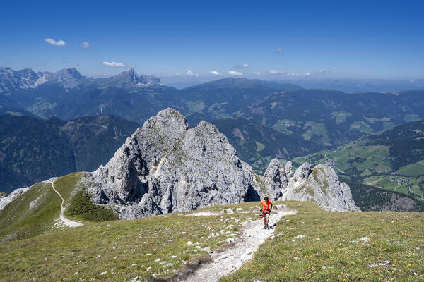 Valdaora / Olang, Bolzano province, South Tyrol, Italy, Europe. A girl hikes the trail to the summit of Piz da Peres