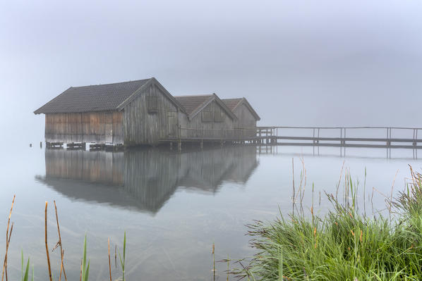 Schlehdorf, Kochel Lake, Bad Tölz-Wolfratshausen district, Upper Bavaria, Germany, Europe. Three boathouses in the Kochel Lake in the early morning