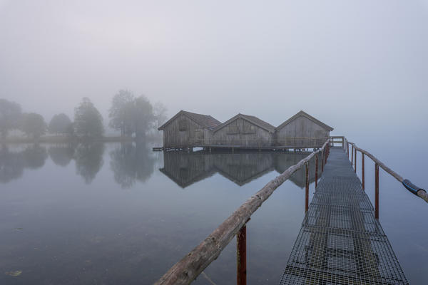 Schlehdorf, Kochel Lake, Bad Tölz-Wolfratshausen district, Upper Bavaria, Germany, Europe. Three boathouses in the Kochel Lake in the early morning