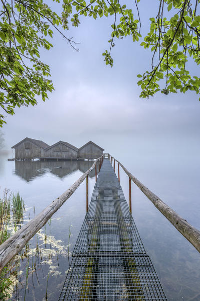 Schlehdorf, Kochel Lake, Bad Tölz-Wolfratshausen district, Upper Bavaria, Germany, Europe. Three boathouses in the Kochel Lake in the early morning