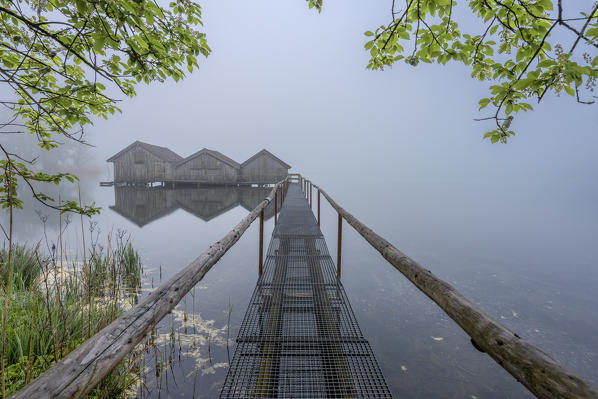 Schlehdorf, Kochel Lake, Bad Tölz-Wolfratshausen district, Upper Bavaria, Germany, Europe. Three boathouses in the Kochel Lake in the early morning