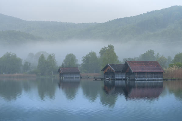 Schlehdorf, Kochel Lake, Bad Tölz-Wolfratshausen district, Upper Bavaria, Germany, Europe. Three boathouses in the Kochel Lake in the early morning