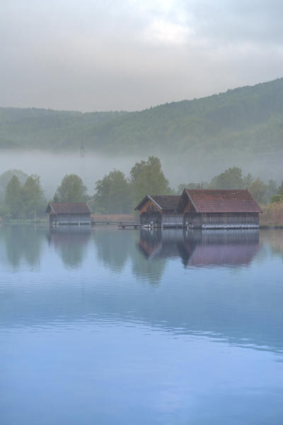 Schlehdorf, Kochel Lake, Bad Tölz-Wolfratshausen district, Upper Bavaria, Germany, Europe. Three boathouses in the Kochel Lake in the early morning