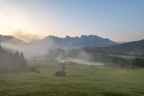 Gerold Lake, Krün, Garmisch-Partenkirchen district, Upper Bavaria, Bavaria, Germany, Europe. Misty sunrise at Gerold Lake with the Karwendel Alps in the background
