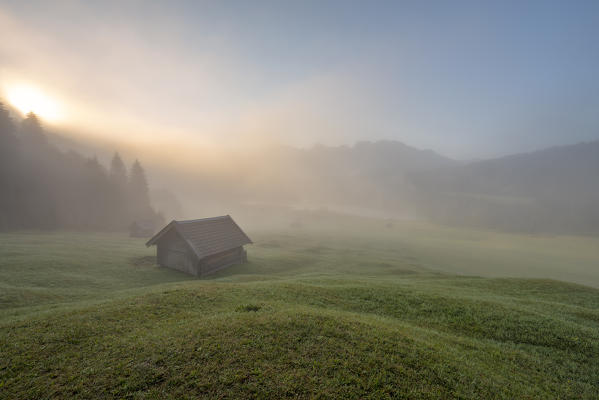 Gerold Lake, Krün, Garmisch-Partenkirchen district, Upper Bavaria, Bavaria, Germany, Europe. Misty sunrise at Gerold Lake with the Karwendel Alps in the background