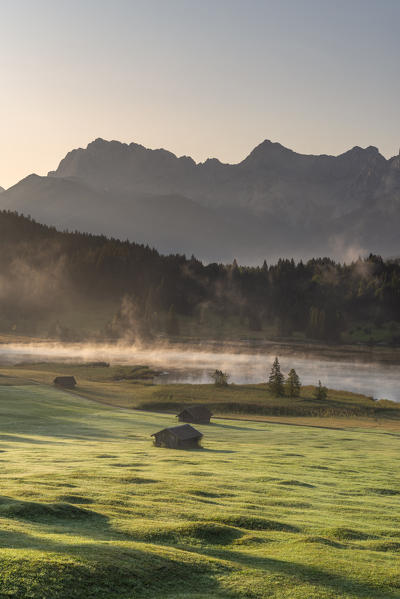 Gerold Lake, Krün, Garmisch-Partenkirchen district, Upper Bavaria, Bavaria, Germany, Europe. Misty sunrise at Gerold Lake with the Karwendel Alps in the background
