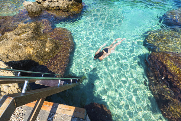 Kallithea,Rhodes,Greece.
Girl swims in the bay of Kallithea.