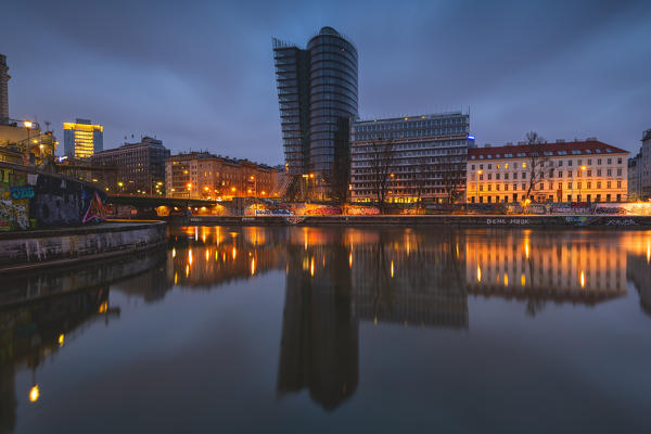 Vienna, Austria, Europe. The Uniqa Tower reflected in the Danube Canal