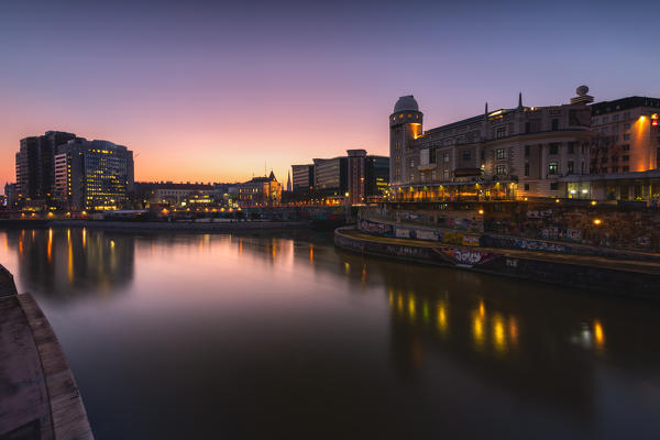Vienna, Austria, Europe. The Urania reflected in the Danube Canal