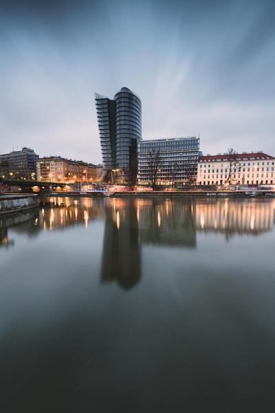 Vienna, Austria, Europe. The Uniqa Tower reflected in the Danube Canal