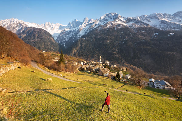 Selfie with the village of Soglio in Bregaglia valley, Switzerland, Europe.