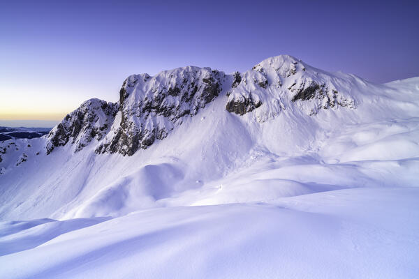 Pizzo Corzene, Presolana Group, and moon at dawn in Orobie Alps, Bergamo province in Lombardy district, Italy, Europe.