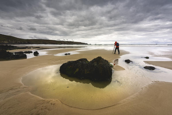 Photographer in Trespasses Bay in Cléden-Cap-Sizun at Dawn, Finistère, Bretagne, France.