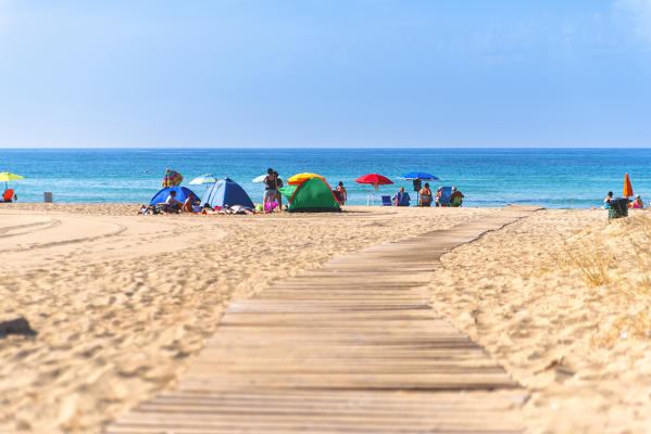 Bathers at the beach, Dune of Campomarino, Taranto province, Apulia, Italy.