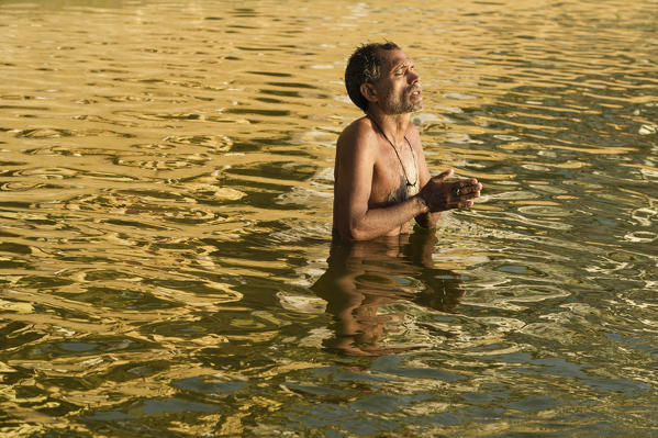 Varanasi, Uttar Pradesh, India, Asia. Morning ablutions in the Ganges.
