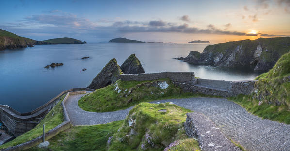 Dunquin pier (Dún Chaoin), Dingle peninsula, County Kerry, Munster province, Ireland, Europe. Panoramic view of the trail at sunset.