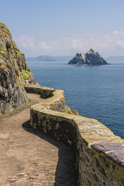 Skellig Michael (Great Skellig), Skellig islands, County Kerry, Munster province, Ireland, Europe. The trail on the cliff with the little Skellig on the background.