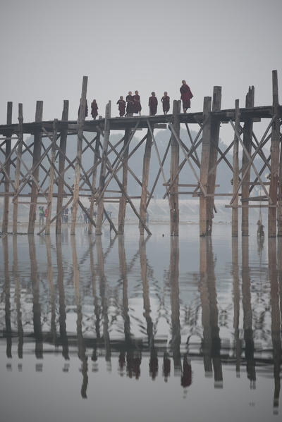 Amarapura, Mandalay region, Myanmar. Monks walking on the U Bein bridge