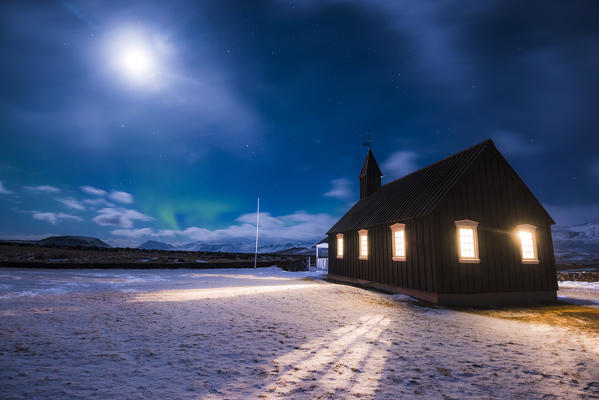 Budir, Snaefellsness peninsula, Western Iceland, Europe. Black church of Budir at night with full moon.