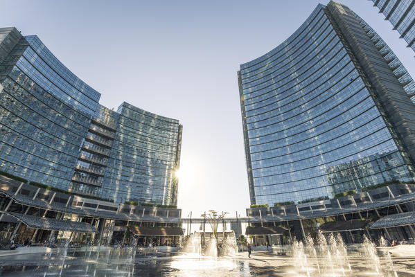 Milan, Lombardy, Italy. People walking the Gae Aulenti square in the Porta Nuova business district.