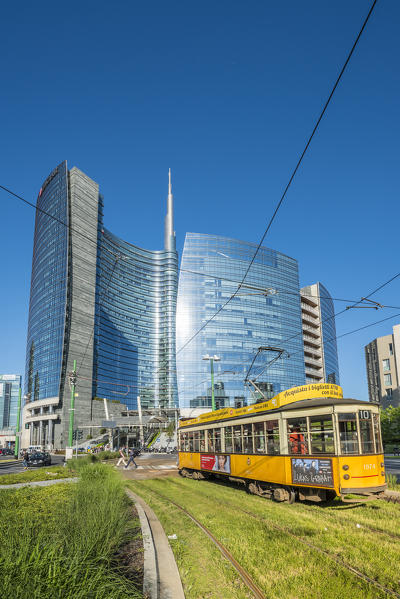 Milan, Lombardy, Italy. Iconic tramway with Porta Nuova business district in the background.
