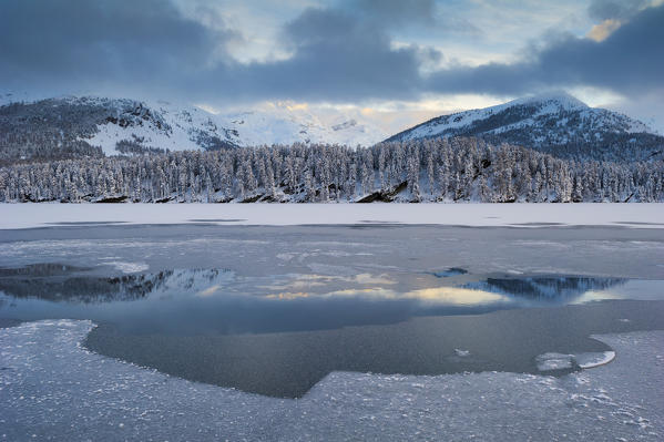 Frozen alpine lake in winter. Engadine, Switzerland