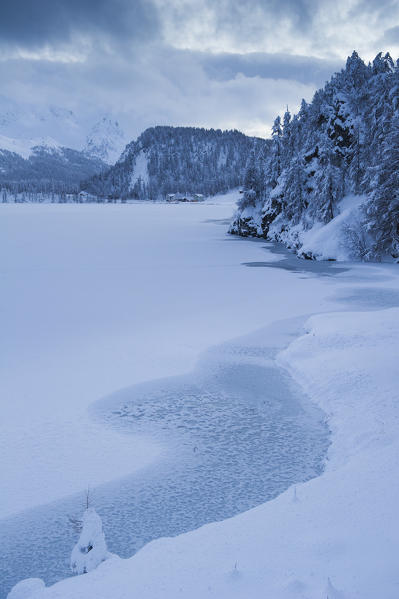 Frozen alpine lake in winter. Engadine, Switzerland