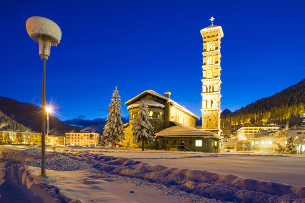 Saint Moritz church lights at dusk with pristine snow. Engadine, Switzerland, Europe