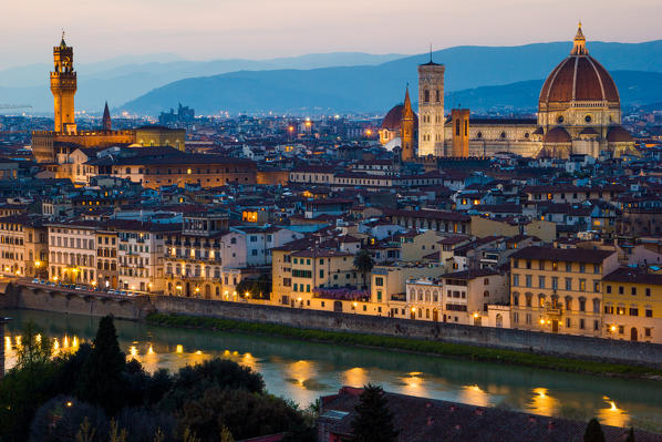 Florence, Tuscany, Italy. Cytiscape with the Cathedral and the Brunelleschi Dome, Giotto Tower at sunset, lights on. 