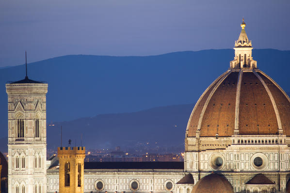 Florence, Tuscany, Italy. Cytiscape with the Cathedral and the Brunelleschi Dome, Giotto Tower at sunset, lights on. 