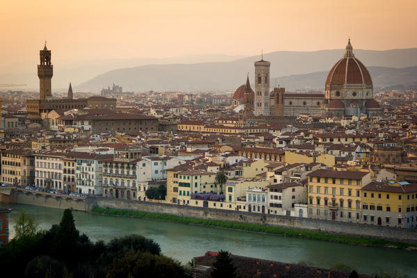 Florence, Tuscany, Italy. cityscape and Cathedral and Brunelleschi Dome, Giotto Tower. Sunset, lights on.