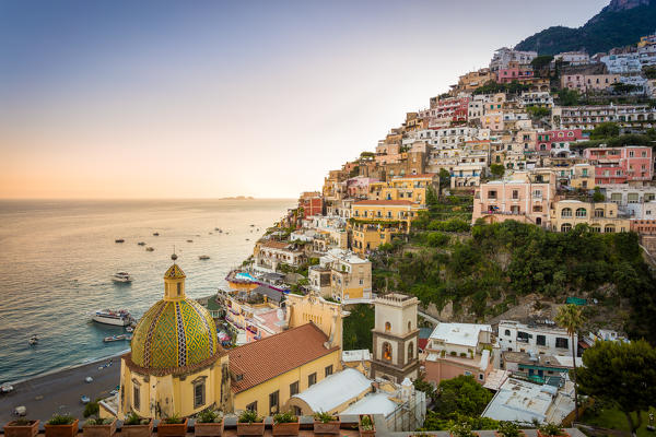Positano, Amalfi Coast, Campania, Sorrento, Italy. View of the town and the seaside in a summer sunset