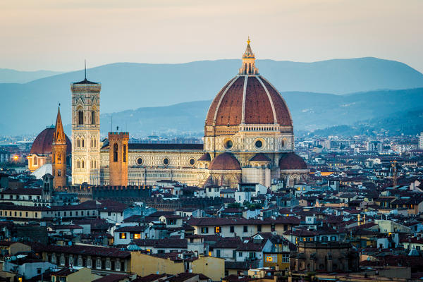 Florence, Tuscany, Italy. Cytiscape with the Cathedral and the Brunelleschi Dome, Giotto Tower at sunset, lights on. 