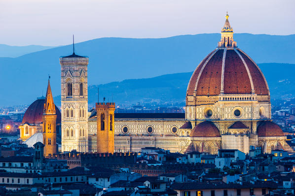 Florence, Tuscany, Italy. Cytiscape with the Cathedral and the Brunelleschi Dome, Giotto Tower at sunset, lights on. 