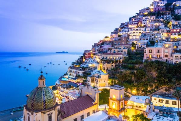 Positano, Amalfi Coast, Campania, Sorrento, Italy. View of the town and the seaside in a summer sunset