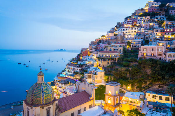 Positano, Amalfi Coast, Campania, Sorrento, Italy. View of the town and the seaside in a summer sunset