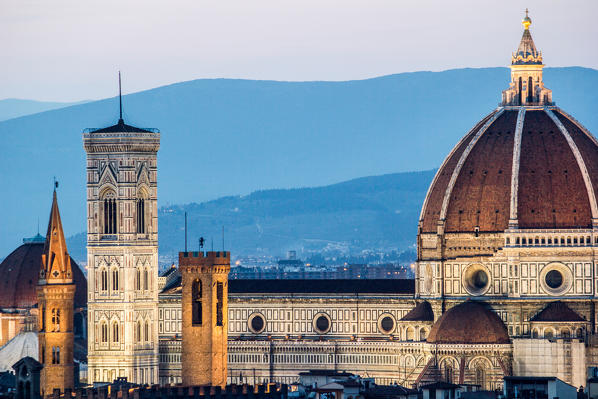 Florence, Tuscany, Italy. cityscape and Cathedral and Brunelleschi Dome, Giotto Tower. Sunset, lights on.