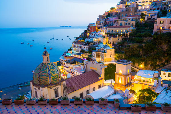 Positano, Amalfi Coast, Campania, Sorrento, Italy. View of the town and the seaside in a summer sunset