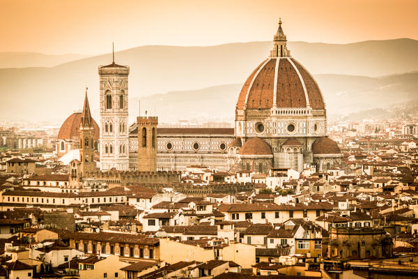Florence, Tuscany, Italy. cityscape and Cathedral and Brunelleschi Dome, Giotto Tower. Sunset, lights on.