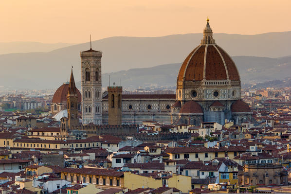 Florence, Tuscany, Italy. cityscape and Cathedral and Brunelleschi Dome, Giotto Tower. Sunset, lights on.